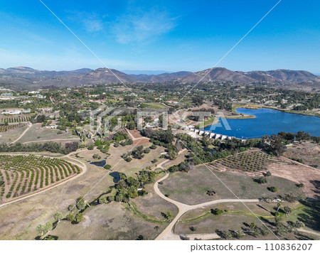 Aerial view over water reservoir and a large dam that holds water. Rancho Santa Fe in San Diego Aerial view over water reservoir and a large dam that holds water. Rancho Santa Fe in San Diego 110836207