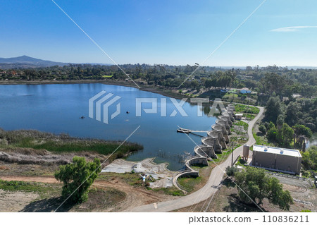 Aerial view over water reservoir and a large dam that holds water. Rancho Santa Fe in San Diego Aerial view over water reservoir and a large dam that holds water. Rancho Santa Fe in San Diego 110836211