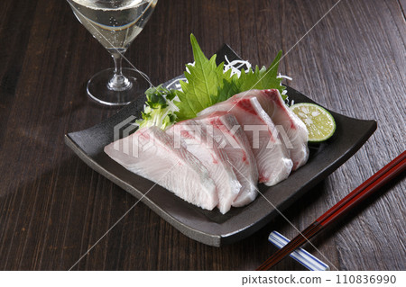 A plate of fatty amberjack sashimi and sparkling A plate of fatty amberjack sashimi and sparkling 110836990