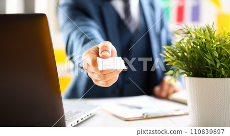 Male arm in suit give blank calling card 110839897