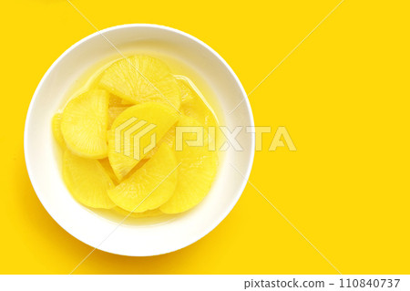 Sweet and tart slices of yellow pickled daikon, known as takuan in Japan and danmuji in Korea. 110840737