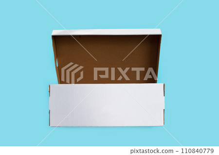 Open empty cardboard box on blue background. Open empty cardboard box on blue background. 110840779