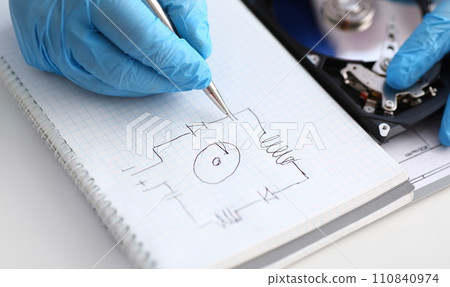 A male repairman in blue protective gloves 110840974