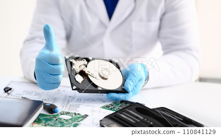 Male repairman wearing blue gloves is 110841129