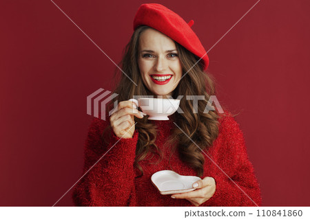 happy woman with long wavy hair, tea cup and heart shape saucer 110841860