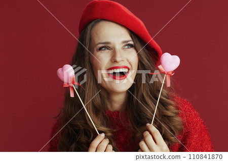 happy elegant female in red sweater and beret 110841870