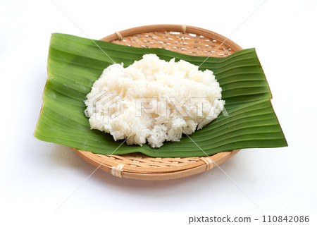 Sticky rice on banana leaf on white background. 110842086