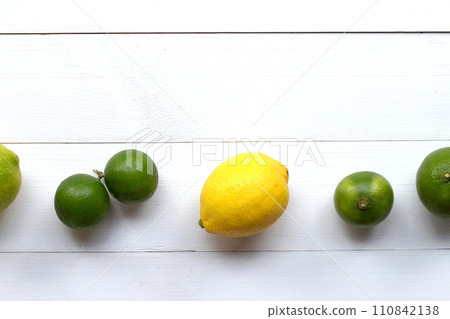 Ripe lemons and limes on white wooden. 110842138