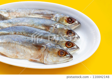 Salted fish on yellow background. Salted fish on yellow background. 110842148