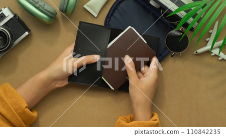 Above view hands holding passport. Ready to Travel, vacation and journey concept. 110842235