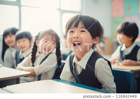 A first grade elementary school boy looks at me and smiles broadly. 110842449