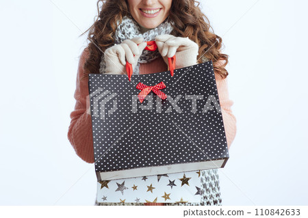 Closeup on trendy woman in sweater, mittens, hat and scarf 110842633
