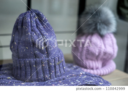 Closeup of purple woolen hats in a fashion store showroom 110842999