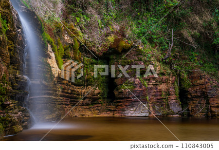 Tranquil Waterfall in Lush Green Forest Scenery Tranquil Waterfall in Lush Green Forest Scenery 110843005