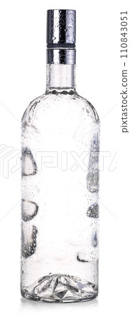 Glass bottle of vodka with drops isolated on white background with clipping path Glass bottle of vodka with drops isolated on white background with clipping path 110843051