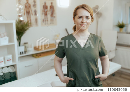 happy female medical massage therapist looking at camera happy female medical massage therapist looking at camera 110843066