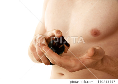 Cropped image of shirtless male body isolated over white background. Young man using cleansing gel for face washing 110843157
