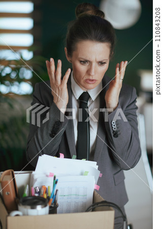 stressed modern woman worker in modern green office 110843208
