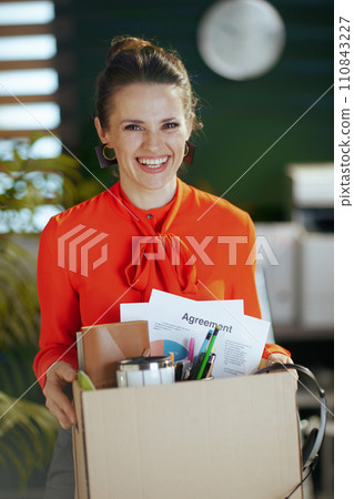 happy modern woman worker in modern green office in red blouse 110843227