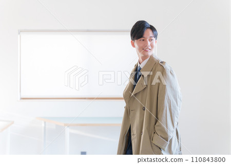 A businessman wearing a coat 110843800