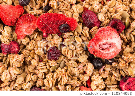 Muesli oat cereals close up background with dry fruits 110844098