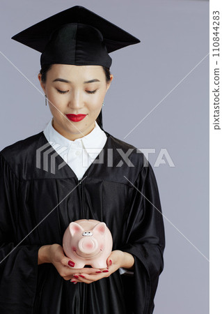 modern female asian graduate student against gray background 110844283