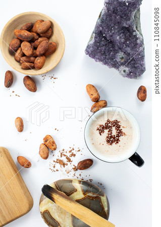Hot cocoa, stick of palo santo wood, cocoa beans, amethyst crystal on white background. Health and benefits for the body 110845098