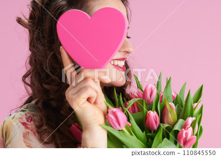 smiling stylish woman with long wavy brunette hair on pink smiling stylish woman with long wavy brunette hair on pink 110845550