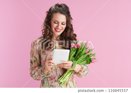 smiling modern woman with long wavy brunette hair on pink smiling modern woman with long wavy brunette hair on pink 110845557