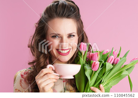 smiling stylish woman with long wavy brunette hair on pink 110845562