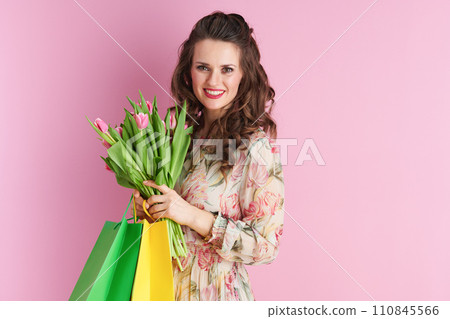smiling woman in floral dress on pink smiling woman in floral dress on pink 110845566