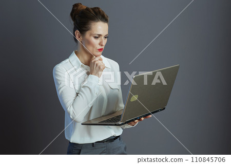 pensive stylish 40 years old woman worker isolated on grey 110845706