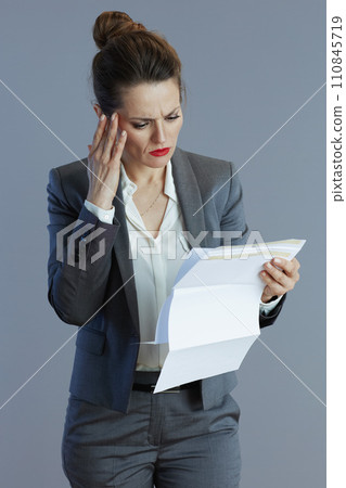 trendy female worker in gray suit isolated on grey trendy female worker in gray suit isolated on grey 110845719