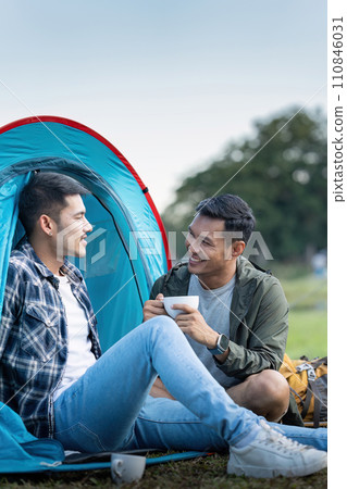 Happy Asian male gay couple on camping together in a forest. romantic vocation trip. lgbt concept Happy Asian male gay couple on camping together in a forest. romantic vocation trip. lgbt concept 110846031