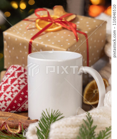 White coffee mug near Christmas present, cosy heart and sweater, winter mockup White coffee mug near Christmas present, cosy heart and sweater, winter mockup 110846510