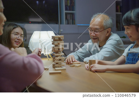 Happy grandparents Asian family enjoy playing toy block with little daughter and mother together at home night time, Smiling parent having fun play build constructor tower of wooden blocks, education Happy grandparents Asian family enjoy playing toy block with little daughter and mother together at home night time, Smiling parent having fun play build constructor tower of wooden blocks, education 110846579