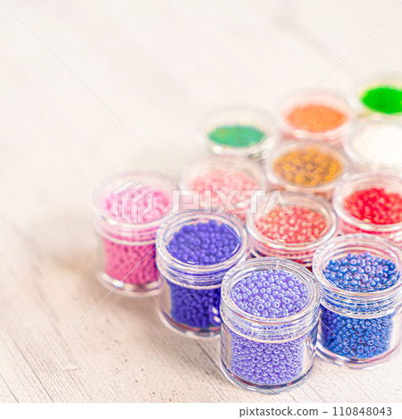 Colorful glass beads. Variety of shapes and colors to make a bead necklace or a string of beads for women 110848043