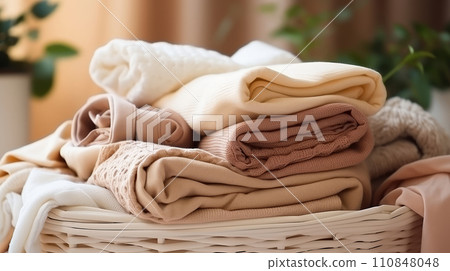 Basket with washed linen and towels. Concept of purity and freshness. Household duties, housework. 110848048