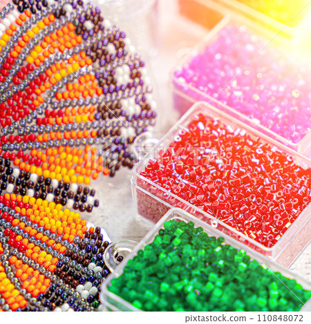 Colorful glass beads. Variety of shapes and colors to make a bead necklace or a string of beads for women 110848072