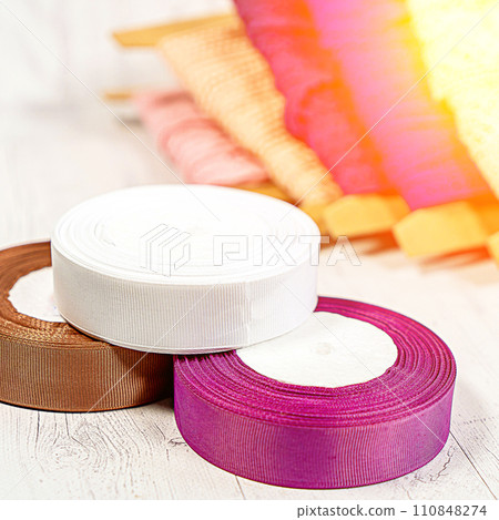 Colored ribbons and lace in coils for hobbies 110848274