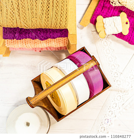 Colored ribbons and lace in coils for hobbies Colored ribbons and lace in coils for hobbies 110848277