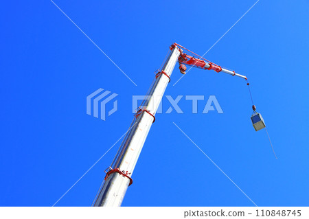 Scenery of a crane truck working at a construction site Scenery of a crane truck working at a construction site 110848745