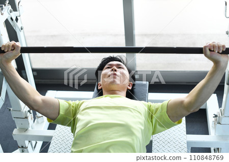 Man training bench press at the gym Man training bench press at the gym 110848769