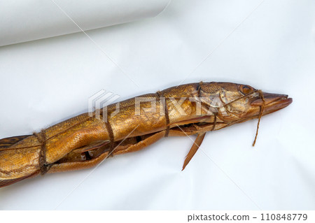 Smoked freshwater pike fish for home use on white paper.. 110848779