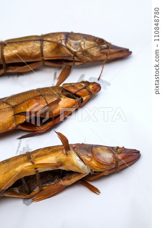 Smoked freshwater zander, pike and common bream fish for home use on white paper.. Smoked freshwater zander, pike and common bream fish for home use on white paper.. 110848780