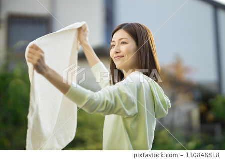 middle-aged woman with laundry 110848818