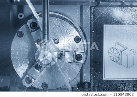 The 4-axis CNC milling machine  cutting the turbocharger part with liquid coolant method. 110848908