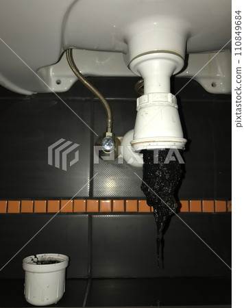 Sink drain clogged with dirty hair and slime 110849684