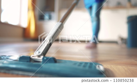 the child baby washed the floors. happy family kid dream concept. daughter washed the floors with a mop in the kitchen in an apron helps mom indoors. mom asked the child girl to mop the floors the child baby washed the floors. happy family kid dream concept. daughter washed the floors with a mop in the kitchen in an apron helps mom indoors. mom asked the child girl to mop the floors 110850238