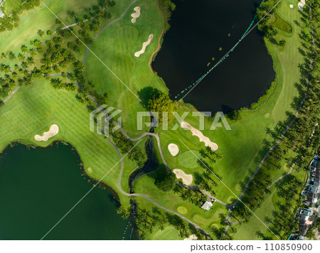 Aerial view of beautiful green golf field fairway and putting green,Top view image for sport background and travel nature background, Amazing green nature view Aerial view of beautiful green golf field fairway and putting green,Top view image for sport background and travel nature background, Amazing green nature view 110850900